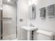 A bathroom features a glass shower, pedestal sink and neutral-colored towels at 214 E St Joseph St, Indianapolis, IN 46202
