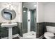 Bathroom featuring a modern pedestal sink, elegant tile work, and a glass shower enclosure with silver fixtures at 214 E St Joseph St, Indianapolis, IN 46202