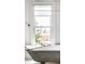 A bath caddy sits on a vintage soaking tub in front of a window with a great view at 214 E St Joseph St, Indianapolis, IN 46202