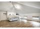 This well-lit bedroom features a murphy bed, hardwood floors, a chandelier, and built-in storage solutions at 214 E St Joseph St, Indianapolis, IN 46202