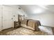 Cozy bedroom featuring a metal bed frame with a decorative nightstand, and light-colored wood flooring at 214 E St Joseph St, Indianapolis, IN 46202