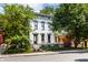 Attractive two-story house with a manicured lawn, mature trees, and a decorative black metal fence at 214 E St Joseph St, Indianapolis, IN 46202