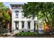 Charming two-story home with a beautifully landscaped front yard and an ornamental fence at 214 E St Joseph St, Indianapolis, IN 46202