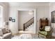 Open foyer showcasing hardwood floors, staircase, and elegant furnishings at 214 E St Joseph St, Indianapolis, IN 46202