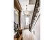 Staircase and foyer featuring hardwood floors, a vintage mirror, and crystal chandelier at 214 E St Joseph St, Indianapolis, IN 46202