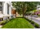 Well-maintained front lawn with manicured hedges and a glimpse of the home's architectural details at 214 E St Joseph St, Indianapolis, IN 46202