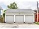 Three-car garage featuring carriage doors and exterior lighting for added convenience and security at 214 E St Joseph St, Indianapolis, IN 46202