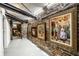 Hallway with exposed brick wall, decorative paintings, and modern lighting, creating an artistic pathway at 214 E St Joseph St, Indianapolis, IN 46202