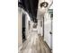 This hallway features a variety of textures, from the wood floor to the exposed utilities on the ceiling at 214 E St Joseph St, Indianapolis, IN 46202