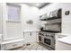 Modern kitchen with stainless steel appliances, custom cabinetry and hardwood floors at 214 E St Joseph St, Indianapolis, IN 46202