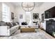 Cozy living room with decorative chandelier, neutral sofa, and fireplace at 214 E St Joseph St, Indianapolis, IN 46202