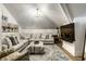 Bright living room features a large sectional sofa, chandelier, and mounted television for cozy entertaining at 214 E St Joseph St, Indianapolis, IN 46202