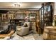 Comfortable lounge features exposed brick, stone, wooden barrel and accents, plus comfortable armchairs and a display case at 214 E St Joseph St, Indianapolis, IN 46202
