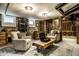Lounge area showing exposed brick and stonework, plus a barrel, comfortable armchairs and shelving at 214 E St Joseph St, Indianapolis, IN 46202