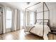 Light-filled main bedroom showcases a canopy bed, hardwood floors, and large windows at 214 E St Joseph St, Indianapolis, IN 46202