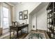 A home office featuring natural light, wood floors, and stylish organization at 214 E St Joseph St, Indianapolis, IN 46202