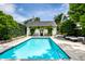 Inviting pool with clear blue water, surrounded by a patio and lush greenery, creating a private oasis at 214 E St Joseph St, Indianapolis, IN 46202