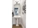Traditional powder room with pedestal sink, gold trimmed mirror, and stylish decor at 214 E St Joseph St, Indianapolis, IN 46202