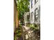 Charming side entrance with a brick path, leading to a welcoming white porch at 214 E St Joseph St, Indianapolis, IN 46202