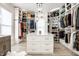 Organized walk-in closet with custom shelving, center island, and stylish lighting at 214 E St Joseph St, Indianapolis, IN 46202