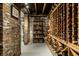 Spacious wine cellar featuring wooden shelving and exposed brick walls for a rustic, elegant feel at 214 E St Joseph St, Indianapolis, IN 46202