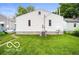 View of the home's backyard, featuring a well-maintained lawn and the home's exterior at 2410 S Ebright St, Muncie, IN 47302