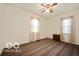 This bedroom features neutral walls, a ceiling fan, and a window that provides natural light at 2410 S Ebright St, Muncie, IN 47302