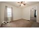 The bedroom is well lit with a large window and has neutral colored paint on the walls at 2410 S Ebright St, Muncie, IN 47302