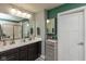 Modern bathroom boasts a double vanity, large mirror, and a glass-enclosed shower with tiled walls at 265 Gathering Ln, Greenwood, IN 46143