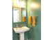 Powder room with stylish pedestal sink, decorative towels and green walls at 265 Gathering Ln, Greenwood, IN 46143