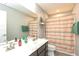 Neutral bathroom featuring a gray vanity, shower with striped curtain, and open shelving at 265 Gathering Ln, Greenwood, IN 46143