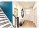 Bright entryway with stylish bench, painted accent wall and staircase at 265 Gathering Ln, Greenwood, IN 46143
