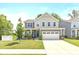 Charming two-story home featuring a well-manicured lawn and attached two-car garage at 265 Gathering Ln, Greenwood, IN 46143