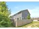 View of home's exterior, complemented by well-maintained yard and a wooden fence for privacy at 265 Gathering Ln, Greenwood, IN 46143