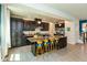 Modern kitchen boasts dark cabinetry, a large granite island with seating, and sleek stainless-steel appliances at 265 Gathering Ln, Greenwood, IN 46143