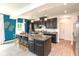 Modern kitchen boasts dark cabinets, granite countertops, a spacious island, and stylish pendant lighting at 265 Gathering Ln, Greenwood, IN 46143