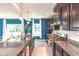 Modern kitchen features stainless steel appliances, granite countertops, a spacious island, and wood floors at 265 Gathering Ln, Greenwood, IN 46143
