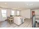 Spacious living area with a large sectional sofa and table for dining, with great lighting at 265 Gathering Ln, Greenwood, IN 46143