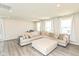 Bright living room with a sectional sofa and an ottoman that offers a comfortable seating arrangement at 265 Gathering Ln, Greenwood, IN 46143