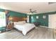 Spacious main bedroom with ensuite bathroom featuring a large bed, stylish decor and hardwood floors at 265 Gathering Ln, Greenwood, IN 46143