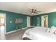 Spacious main bedroom with ensuite bathroom featuring a large bed, stylish decor and hardwood floors at 265 Gathering Ln, Greenwood, IN 46143