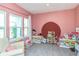 Bright playroom with pink walls, large windows, and ample space for toys and activities at 265 Gathering Ln, Greenwood, IN 46143