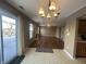 Open-concept living room featuring hardwood floors, a cozy fireplace, and a stylish chandelier at 2734 Mingo Ct, Indianapolis, IN 46217