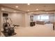 Spacious basement area includes a workout space and a cozy sitting area with comfortable sectional sofa at 2901 Hazel Foster Dr, Carmel, IN 46033
