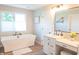 Bright bathroom with a soaking tub, double vanity, and a window for natural light at 2901 Hazel Foster Dr, Carmel, IN 46033
