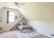 Slanted bedroom featuring a dormer window, carpet floors, and a cozy bed at 2901 Hazel Foster Dr, Carmel, IN 46033