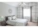 Charming bedroom features patterned wallpaper accent wall and a comfortable bed with stylish linens at 2901 Hazel Foster Dr, Carmel, IN 46033