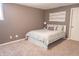 Comfortable bedroom features a queen bed, soft carpet, and contemporary artwork on the wall at 2901 Hazel Foster Dr, Carmel, IN 46033