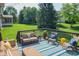 Inviting outdoor deck with stylish furniture, bright accents, and a serene view of the lush backyard at 2901 Hazel Foster Dr, Carmel, IN 46033