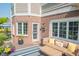 Relaxing outdoor deck with comfortable seating, stylish rug, flowers, and partial brick exterior at 2901 Hazel Foster Dr, Carmel, IN 46033